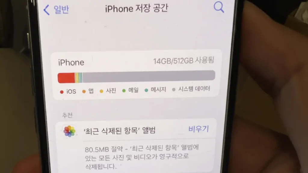 아이폰 저장 공간에서 기타 시스템 데이터(회색 막대)가 높게 표시된 화면을 확인하는 모습.